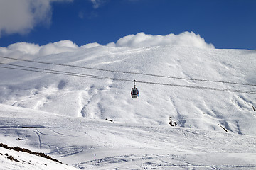 Image showing Gondola lift and ski slope at sun day