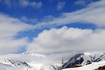 Image showing Ski slope and blue sky with clouds