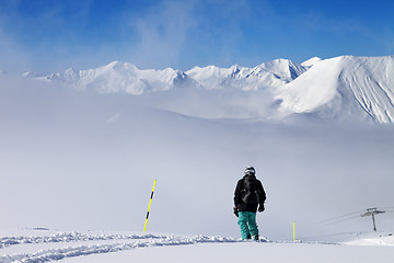 Image showing Snowboarder on snowy slope with new fallen snow