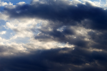 Image showing Sunny sky with dark clouds