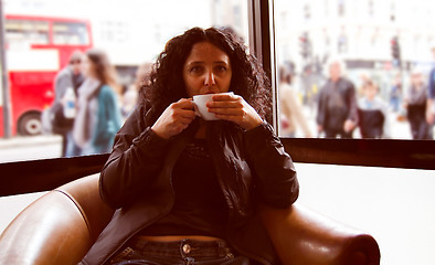 Image showing Pretty brunette drinking coffee tea