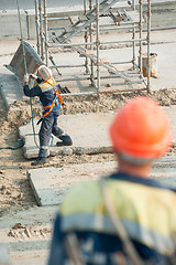 Image showing Worker levels provision of plate lifting by crane