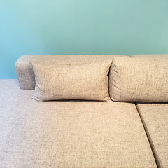 Image showing Sofa with cushions near green wall