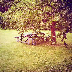 Image showing Wooden table in summer garden