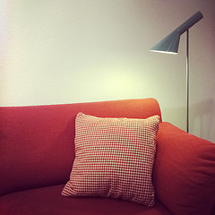 Image showing Red sofa with cushion and lamp