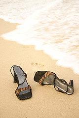 Image showing Kick off your heels - Sandals on seashore