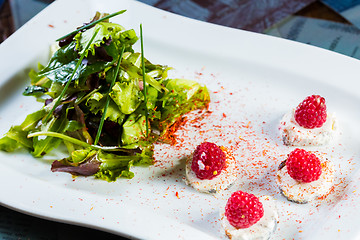 Image showing fresh salad with goat cheese and raspberry.