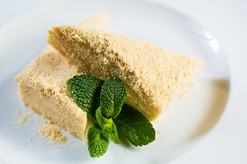 Image showing Cake Napoleon of puff pastry with sour cream on a plate.