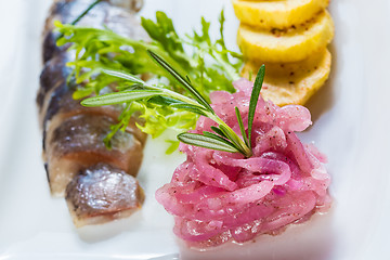 Image showing Herring with fried potatoes and red onions