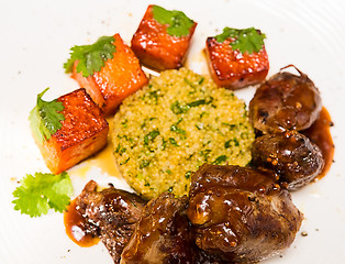Image showing Organic meat of lamb cooked with slices pumpkin and quinoa in oriental style