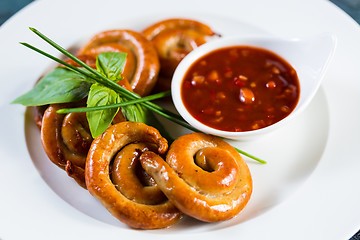 Image showing organic grilled sausages on a white plate.