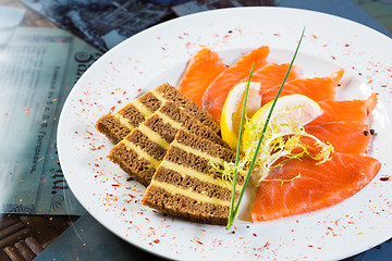 Image showing Salmon snack on the white plate,