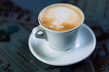 Image showing Cup of coffee on a wooden table