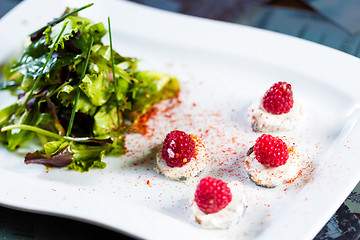 Image showing fresh salad with goat cheese and raspberry.