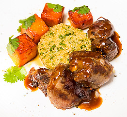 Image showing Organic meat of lamb cooked with slices pumpkin and quinoa in oriental style