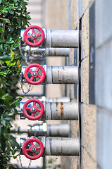 Image showing multiple fire department connections on a building wall