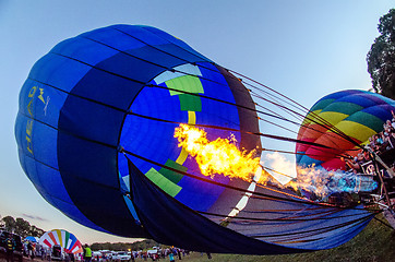 Image showing Fire heats the air inside a hot air balloon at balloon festival 