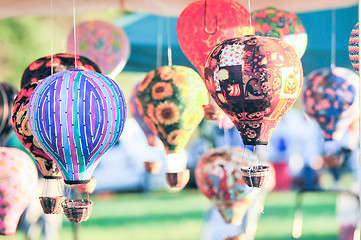 Image showing bunch of hot air balloon toys dangling in the wind