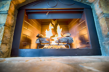 Image showing luxurious stone structure fireplace with burning fire
