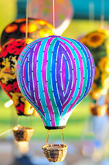 Image showing bunch of hot air balloon toys dangling in the wind