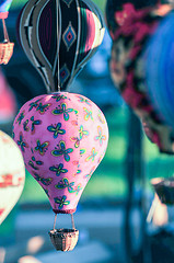 Image showing bunch of hot air balloon toys dangling in the wind