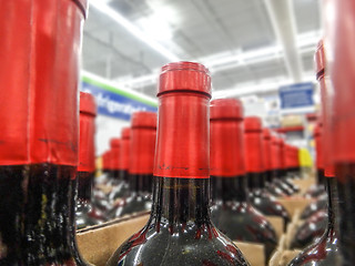 Image showing wine bottles stacked on wooden racks shot with limited depth of 