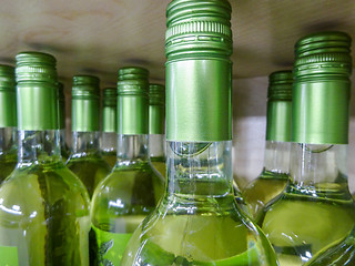 Image showing wine bottles stacked on wooden racks shot with limited depth of 