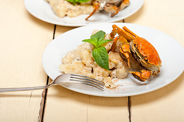 Image showing Italian gnocchi with seafood sauce with crab and basil