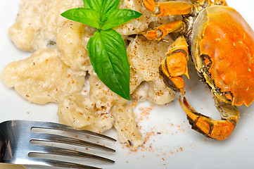 Image showing Italian gnocchi with seafood sauce with crab and basil