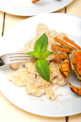 Image showing Italian gnocchi with seafood sauce with crab and basil