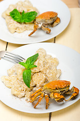 Image showing Italian gnocchi with seafood sauce with crab and basil