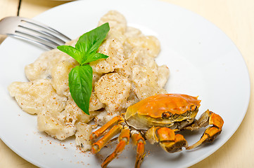 Image showing Italian gnocchi with seafood sauce with crab and basil