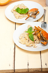 Image showing Italian gnocchi with seafood sauce with crab and basil