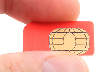 Image showing cellphone cimcard in the human fingers 