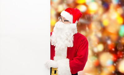 Image showing man in costume of santa claus with billboard