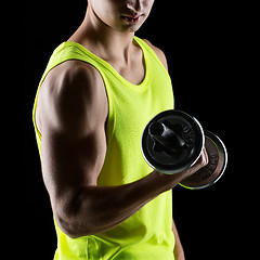 Image showing close up of young man with dumbbell