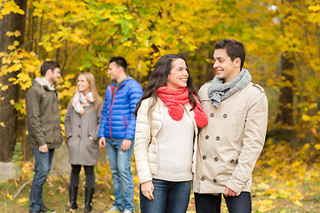 Image showing group of smiling men and women in autumn park