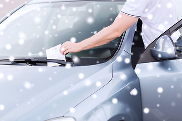 Image showing close up of man with parking ticket on car