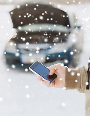 Image showing closeup of man with broken car and smartphone