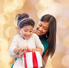 Image showing happy mother and little girl with gift box