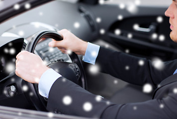 Image showing close up of businessman driving car