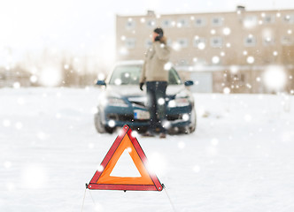 Image showing closeup of man with broken car and smartphone