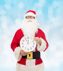 Image showing man in costume of santa claus with clock