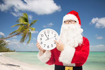 Image showing man in costume of santa claus with clock