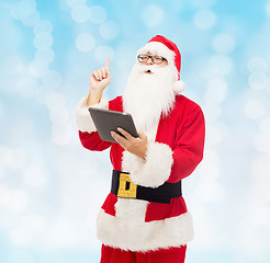 Image showing man in costume of santa claus with tablet pc