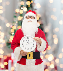 Image showing man in costume of santa claus with clock