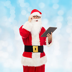 Image showing man in costume of santa claus with tablet pc