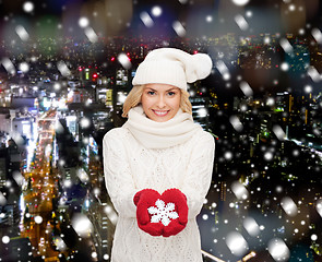 Image showing smiling woman in winter clothes with snowflake