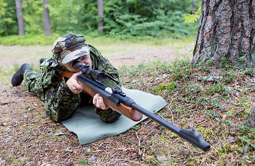 Image showing young soldier or hunter with gun in forest