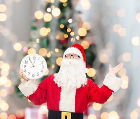 Image showing man in costume of santa claus with clock